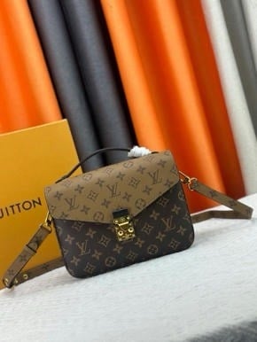 Pochette Métis Monogram Reverse Bag in brown and tan