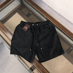 Embossed Monogram Swim Trunks in black
